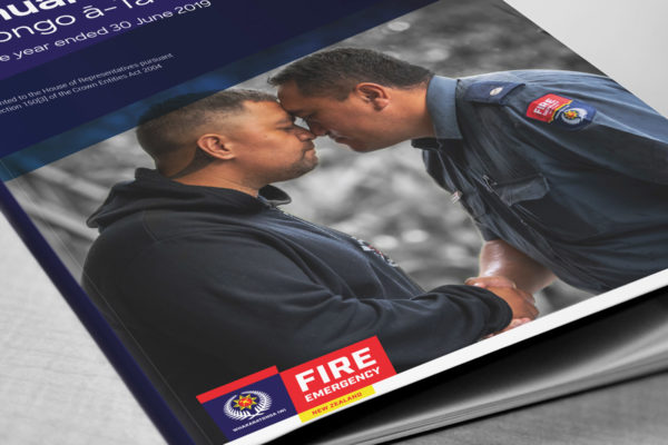 Book cover design with male firefighters following corporate brand guidelines by creative agency Wonderlab.