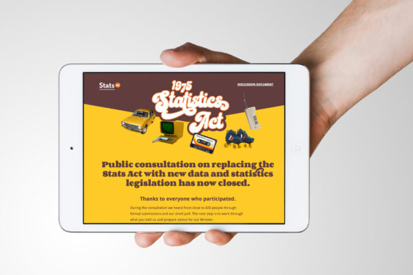 Hand holding a tablet with a retro-style public awareness website design by Wonderlab