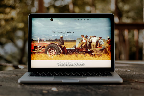 Laptop with a vintage tractor and typography for a wine web site created by Wonderlab.