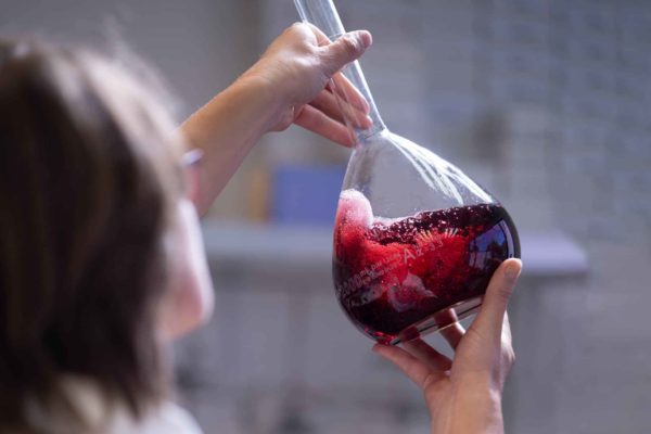 Women holding a beaker of wine, photography used by web designers Wonderlab