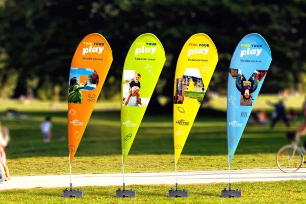 Four banner flags at a park, branded by Wellington design agency Wonderlab.