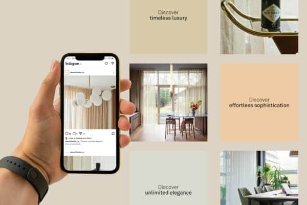 Hand holding a smartphone displaying an interior design Instagram post. Background features images of modern, elegant interiors with text: "Discover timeless luxury," "effortless sophistication," "unlimited elegance.